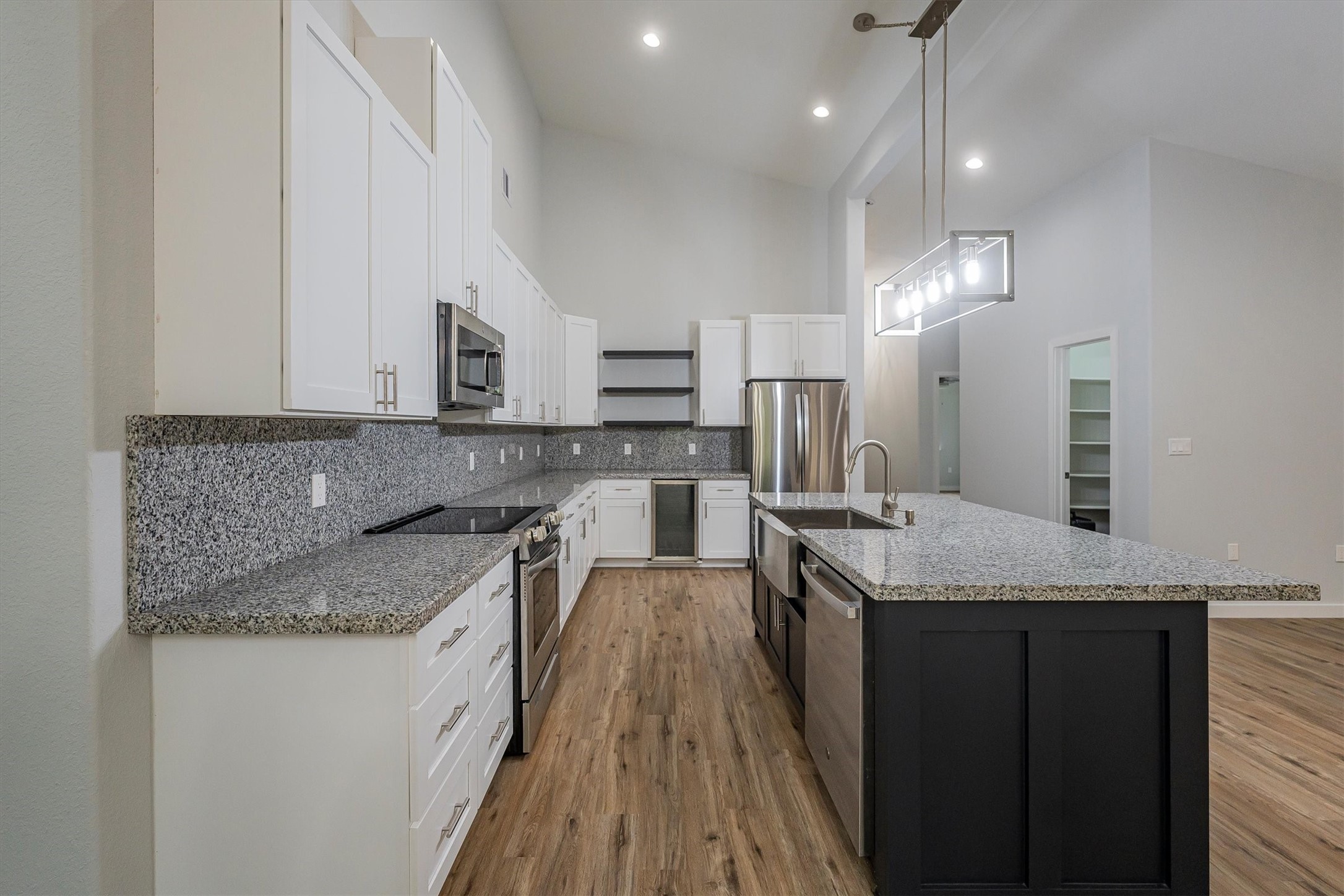 24411 Oakaland Hls Road Point Blank, TX 77364 - Photo 11 of 40 a kitchen with stainless steel appliances granite countertop a sink stove and cabinets