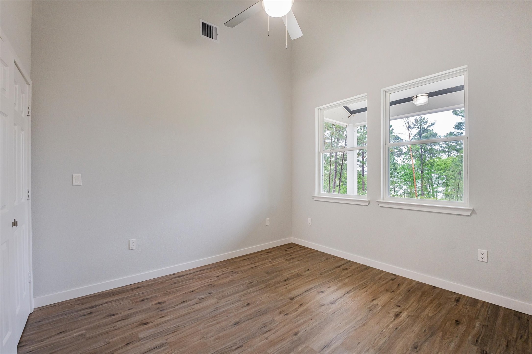 24411 Oakaland Hls Road Point Blank, TX 77364 - Photo 17 of 40 wooden floor in an empty room with a window