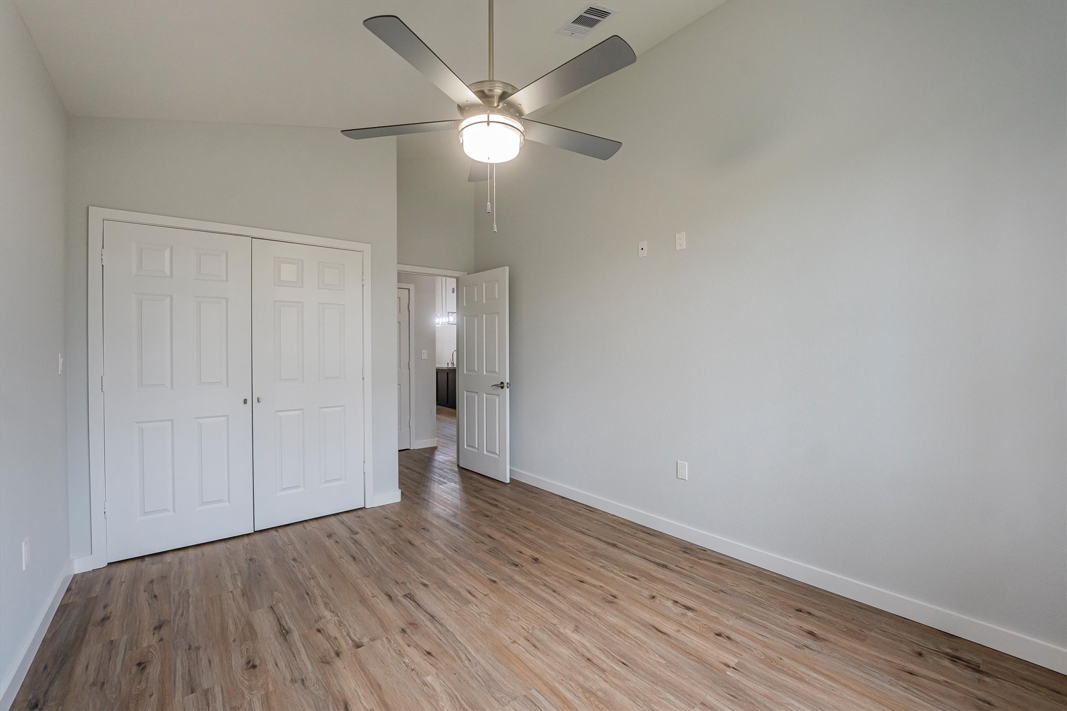 24411 Oakaland Hls Road Point Blank, TX 77364 - Photo 20 of 40 a view of an empty room with wooden floor