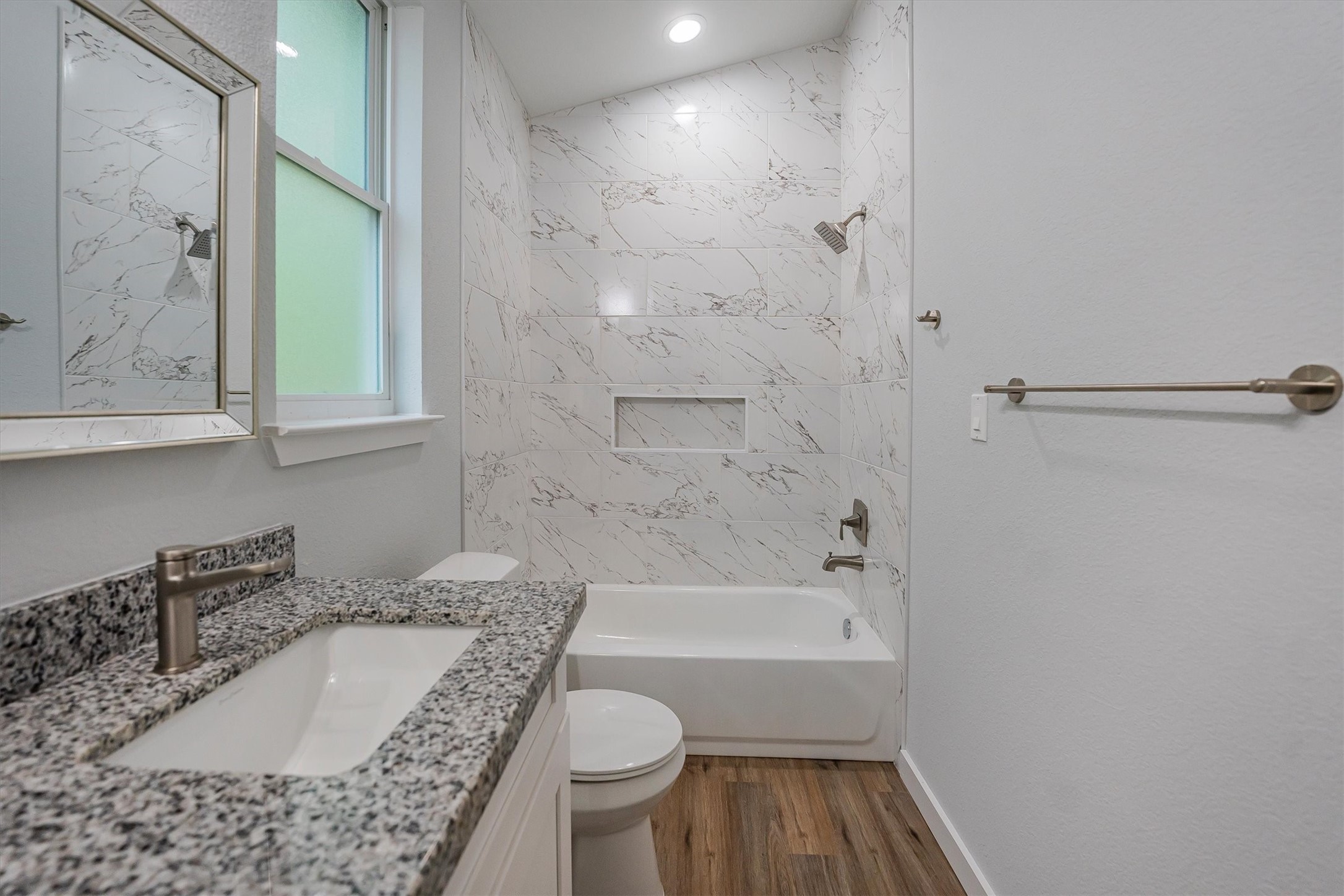 24411 Oakaland Hls Road Point Blank, TX 77364 - Photo 22 of 40 a bathroom with a granite countertop sink a toilet and bathtub