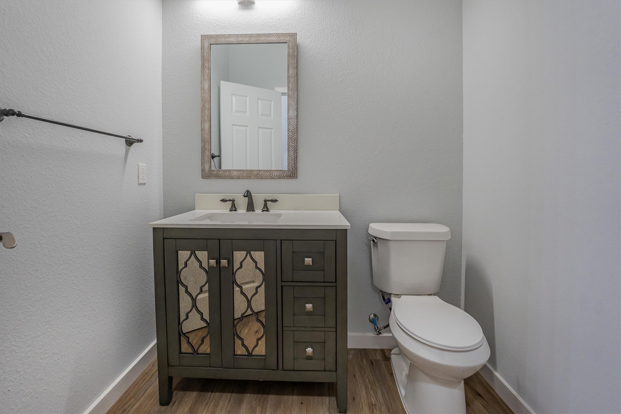 24411 Oakaland Hls Road Point Blank, TX 77364 - Photo 23 of 40 a bathroom with a toilet sink and mirror