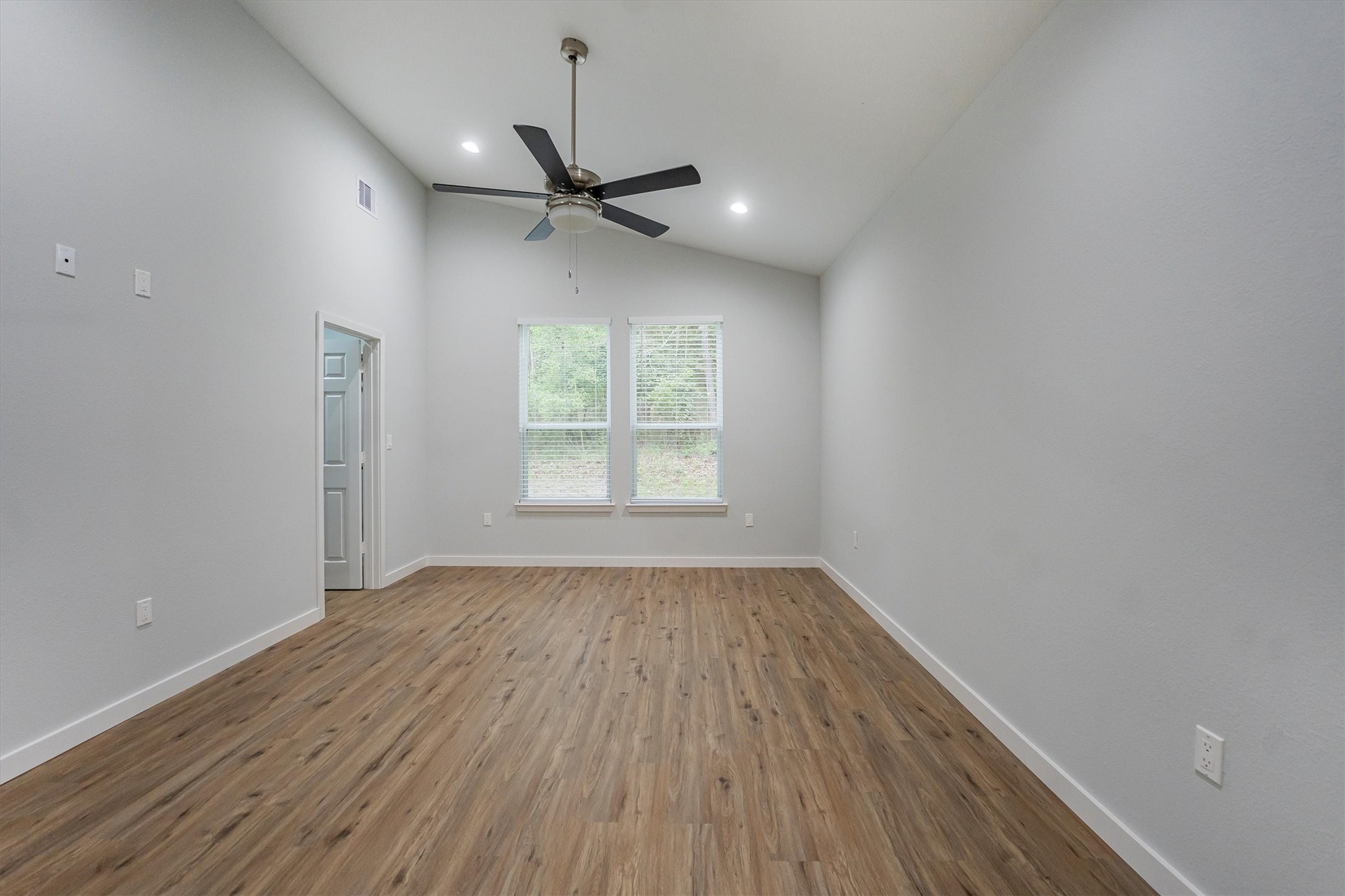 24411 Oakaland Hls Road Point Blank, TX 77364 - Photo 25 of 40 wooden floor in an empty room with a window