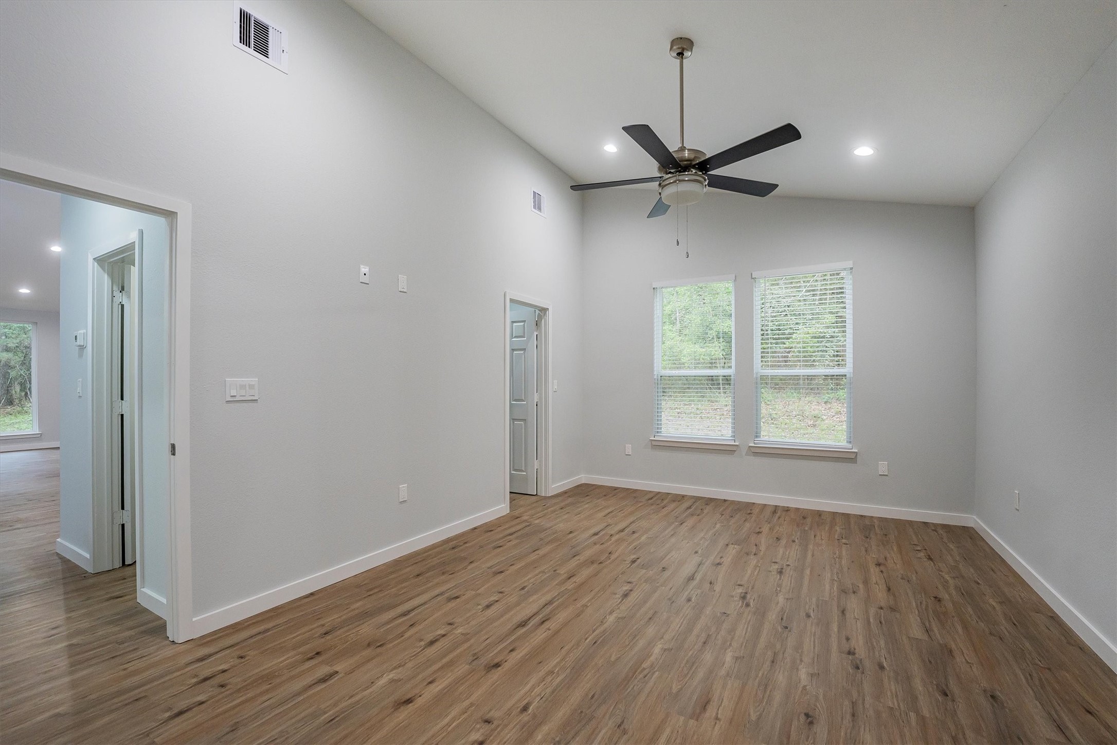 24411 Oakaland Hls Road Point Blank, TX 77364 - Photo 26 of 40 wooden floor in an empty room with a window