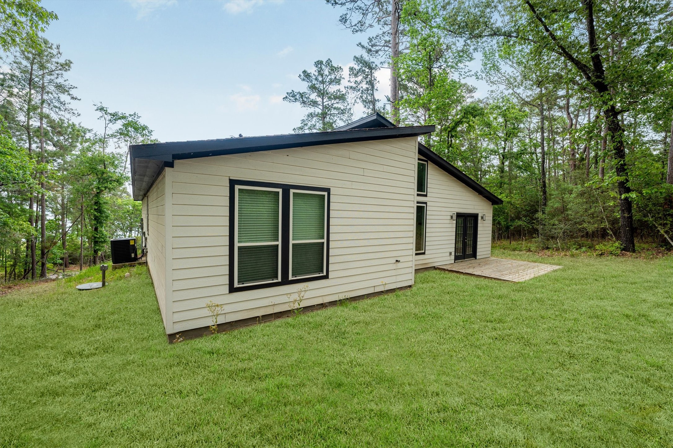 24411 Oakaland Hls Road Point Blank, TX 77364 - Photo 37 of 40 a view of a house with a backyard