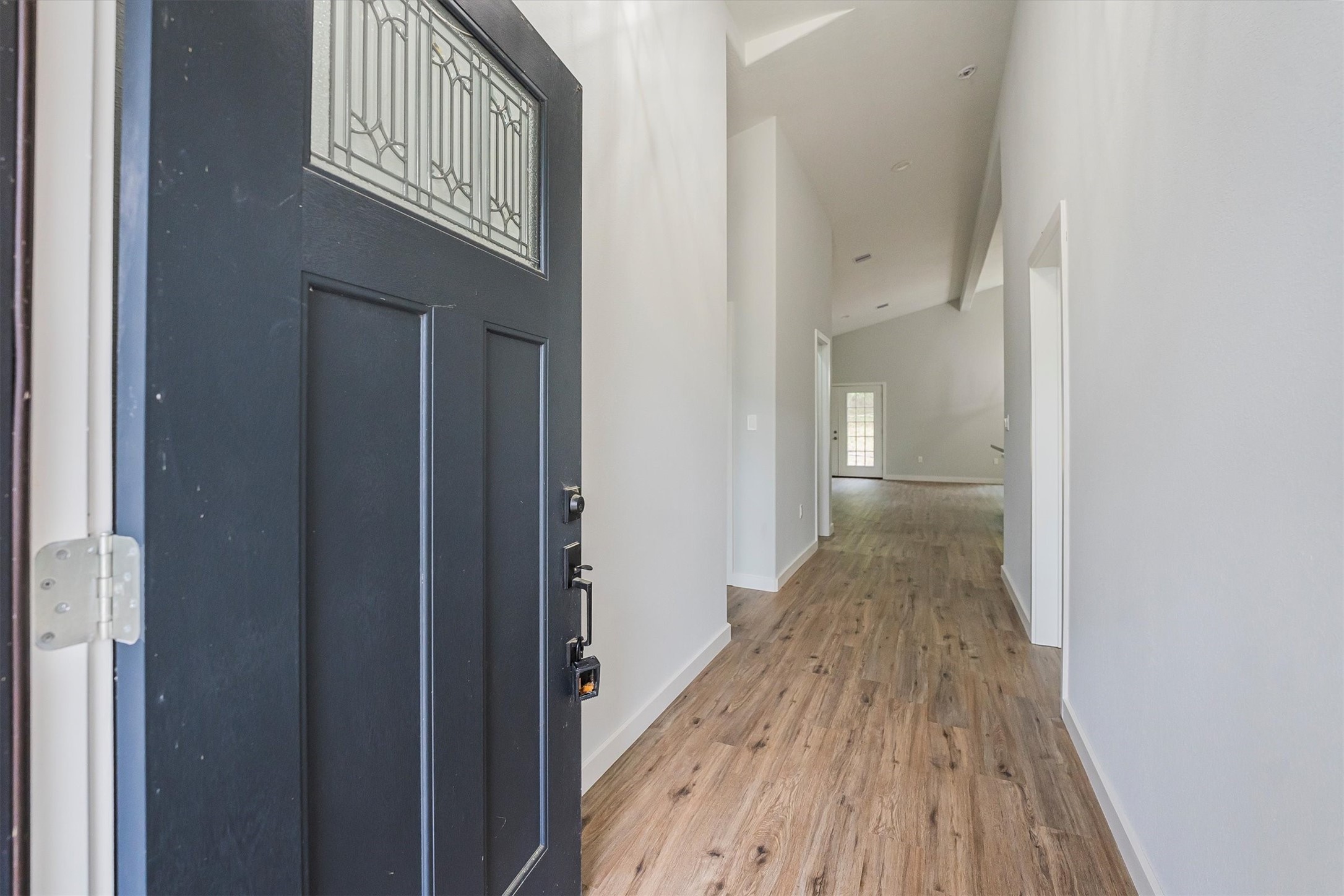 24411 Oakaland Hls Road Point Blank, TX 77364 - Photo 5 of 40 a view of a hallway with wooden floor and entryway