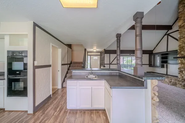 a kitchen with stainless steel appliances granite countertop a sink a stove and a refrigerator