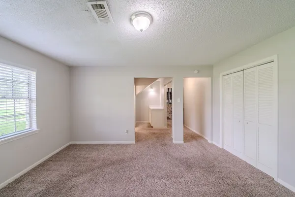 an empty room with a empty space and windows