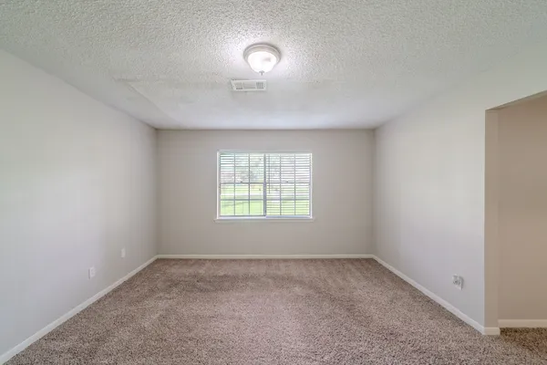 an empty room with a empty space and windows