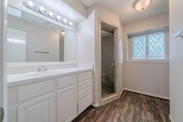 a bathroom with a double vanity sink and mirror