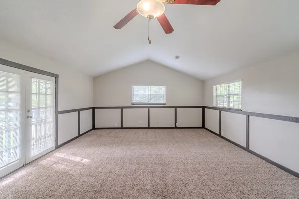 a view of an empty room with windows