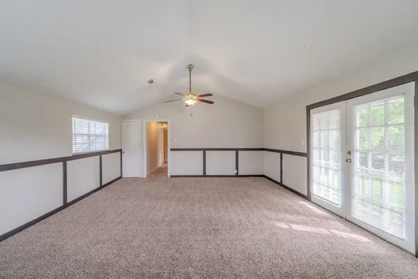 a view of a livingroom with a ceiling fan and window