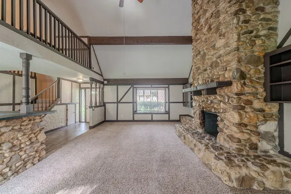 a view of an empty room with a fireplace