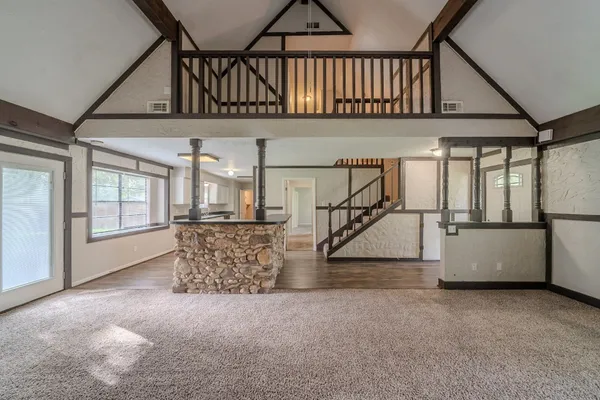 a view of a room with wooden floor and window