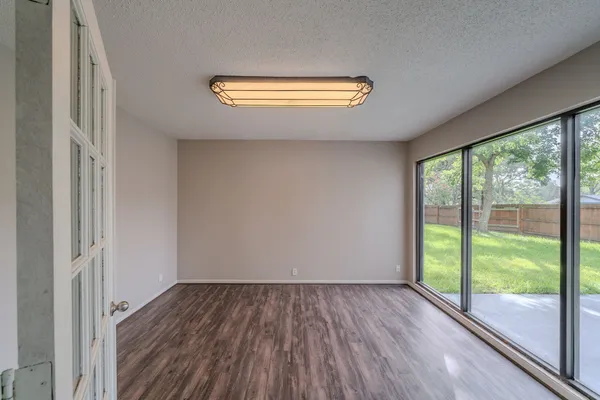 a view of a room with wooden floor and window