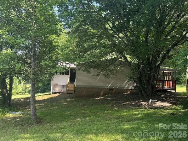 a view of a tree in front of a house