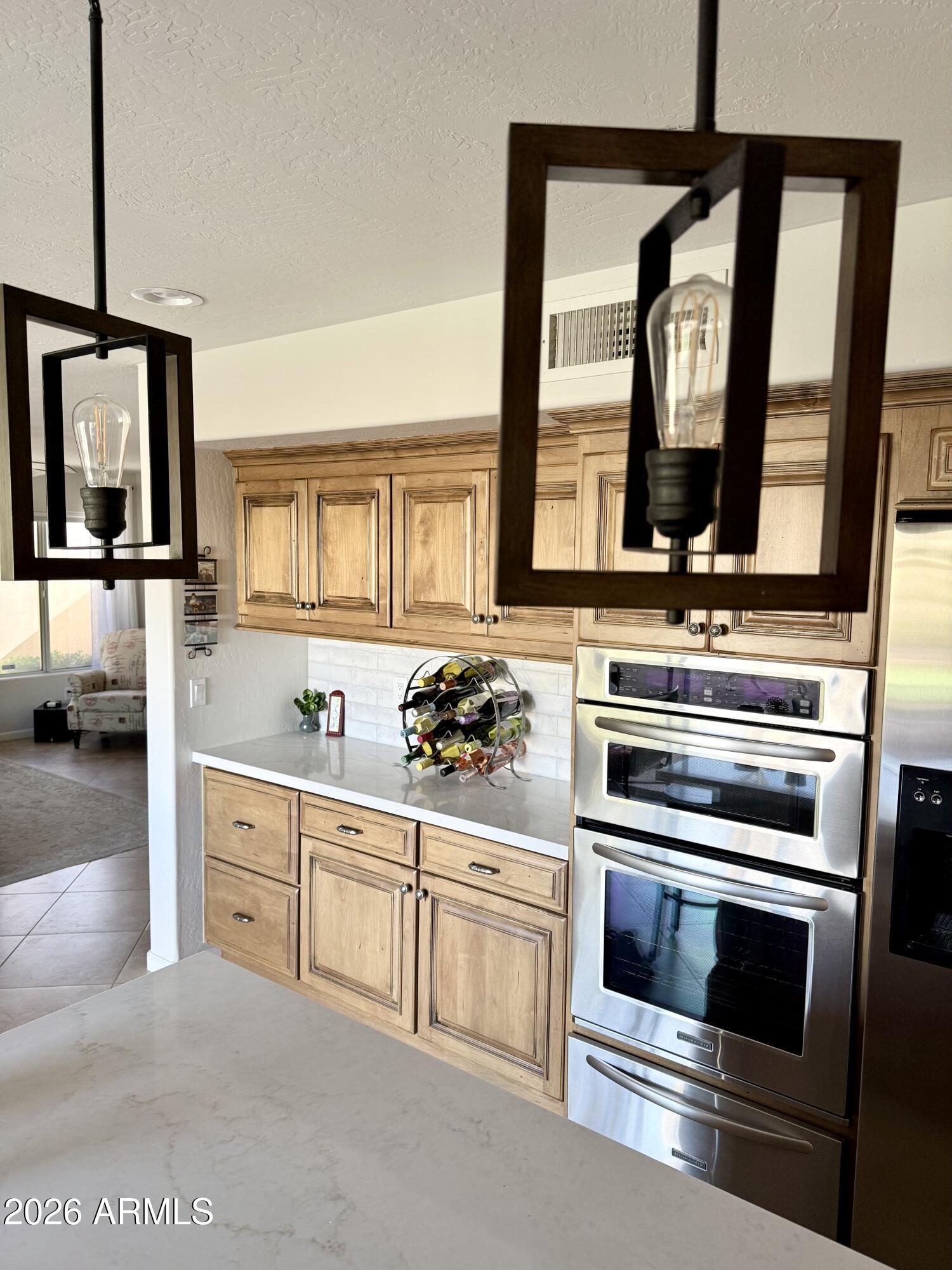 3426 East Clark Road Phoenix, AZ 85050 - Photo 12 of 48 a kitchen with white cabinets and a stove