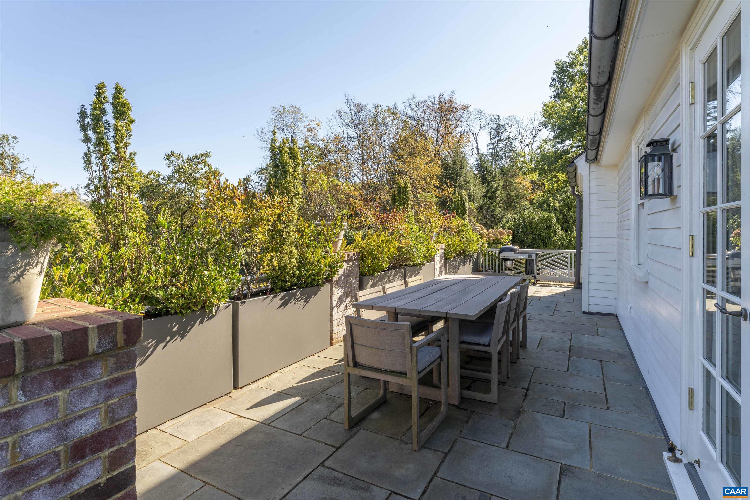 651 Ivy Depot Road Charlottesville, VA 22903 - Photo 17 of 72 a view of a backyard with table and chairs and potted plants