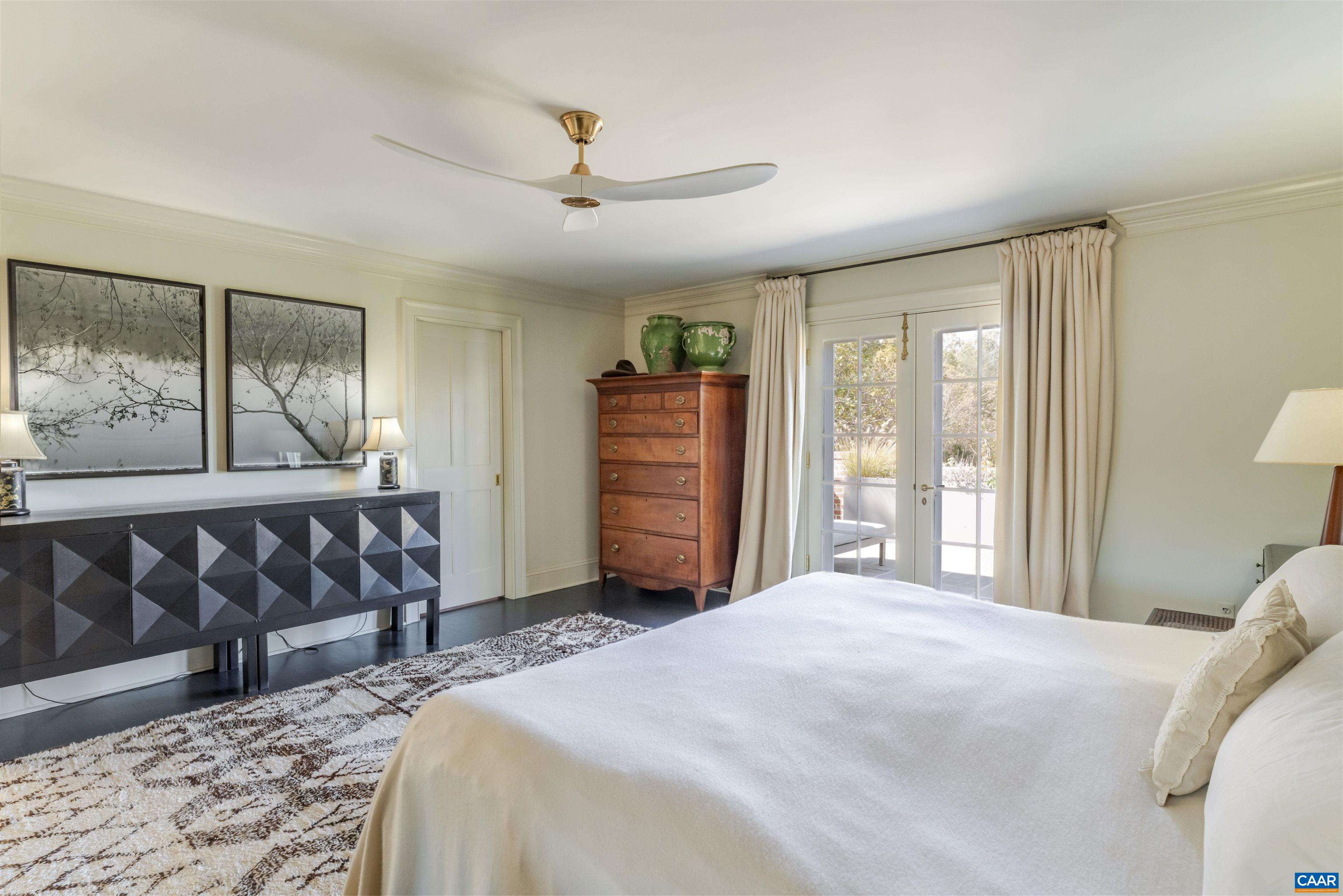 651 Ivy Depot Road Charlottesville, VA 22903 - Photo 28 of 72 a bedroom with a large bed and a chandelier