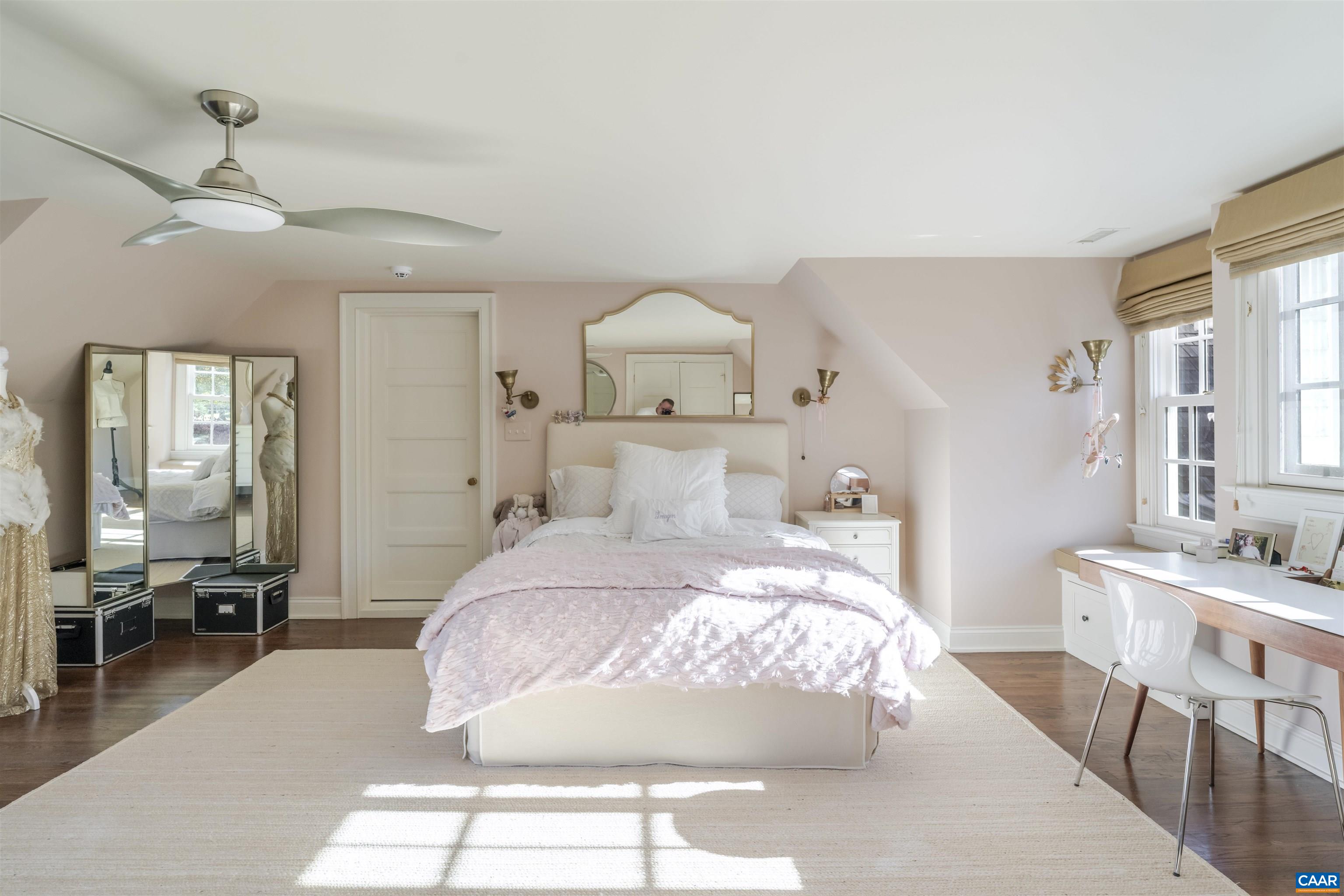 651 Ivy Depot Road Charlottesville, VA 22903 - Photo 40 of 72 a bedroom with a large bed and a chandelier