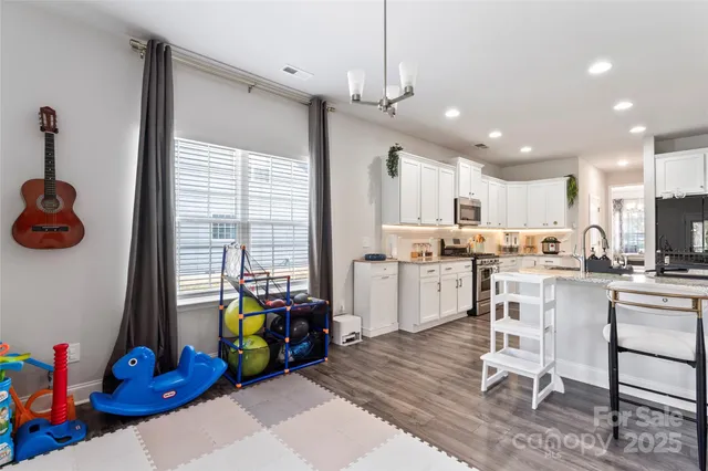 a kitchen that has a lot of cabinets a sink and appliances in it
