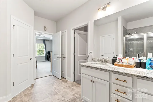 a spacious bathroom with a granite countertop sink mirror and a