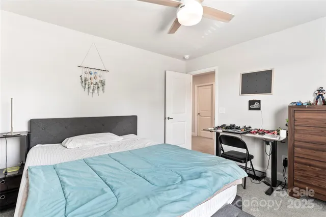 a bedroom with a bed and a desk