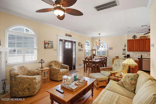 a living room with furniture ceiling fan and a window