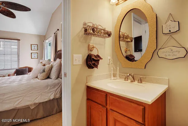 a en suite bathroom with a sink and a mirror