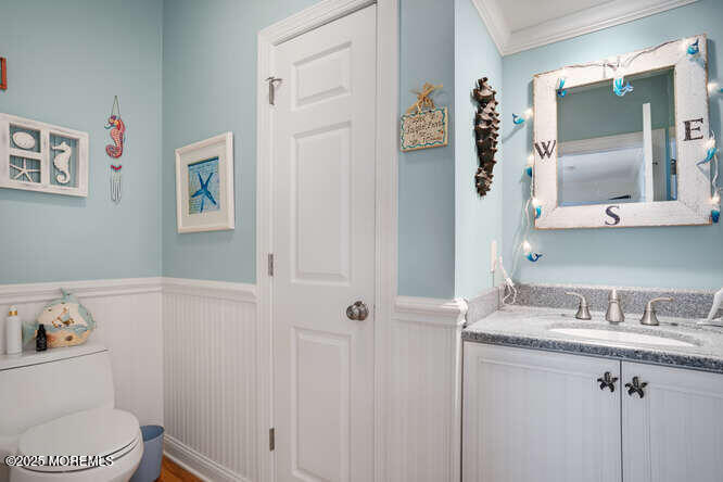 55 Barnegat Way Lavallette, NJ 08735 - Photo 24 of 26 a bathroom with a sink vanity mirror and toilet