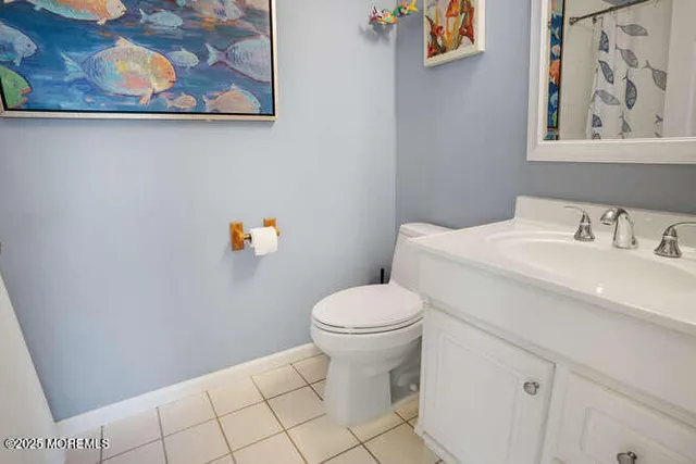 a white toilet sitting next to a bathroom sink