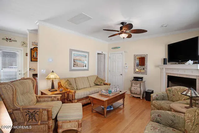 a living room with furniture a fireplace and a flat screen tv