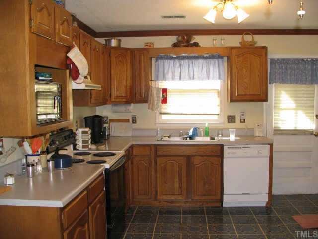 901 Buckhorn Road Garner, NC 27529 - Photo 2 of 6 a kitchen with a sink stove and cabinets