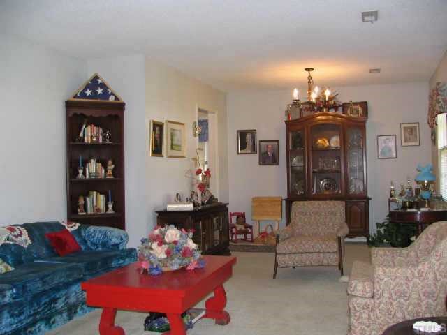 901 Buckhorn Road Garner, NC 27529 - Photo 4 of 6 a living room with furniture and chandelier