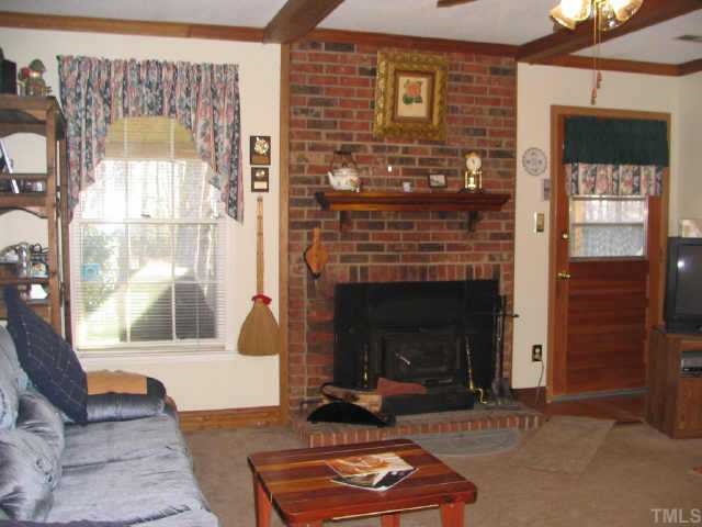 901 Buckhorn Road Garner, NC 27529 - Photo 5 of 6 a living room with furniture and a fireplace