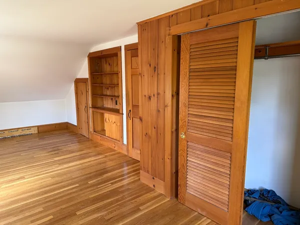 a view of a room with wooden floor and bathroom