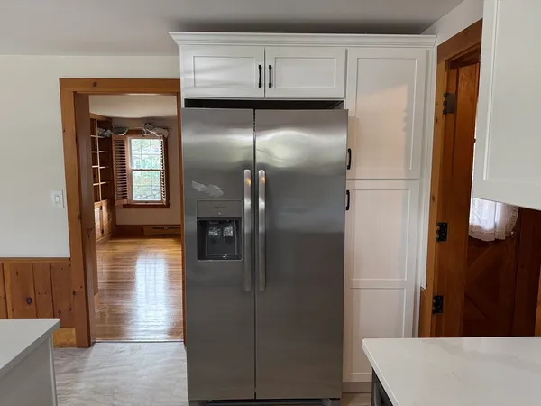 a kitchen with a refrigerator and cabinets