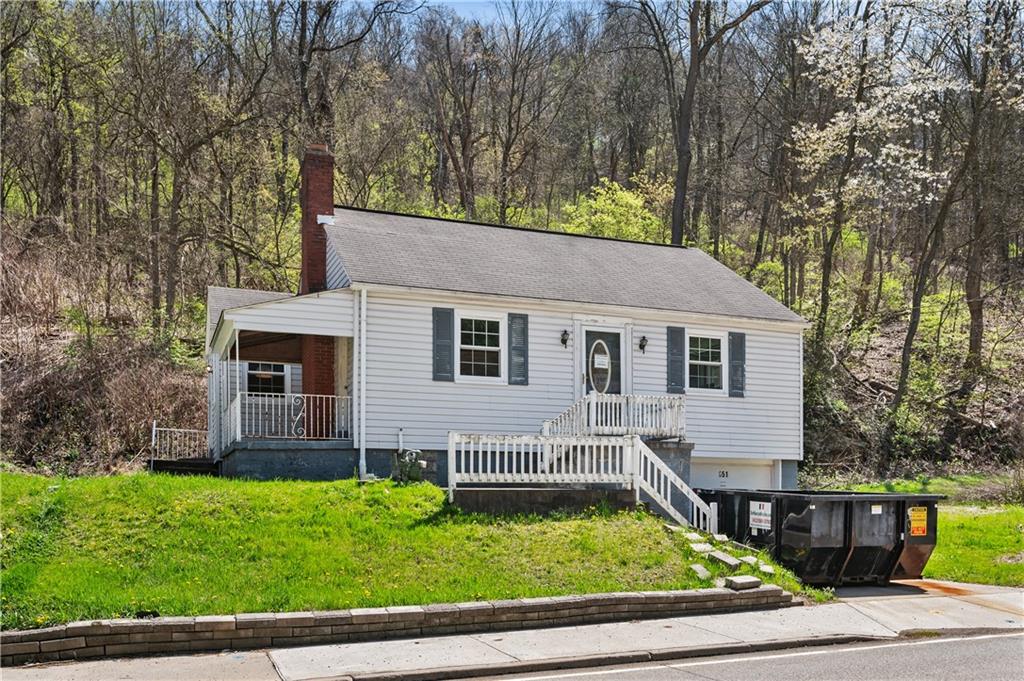 a view of house with a yard