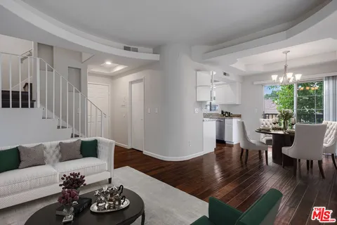 a living room with furniture window and wooden floor