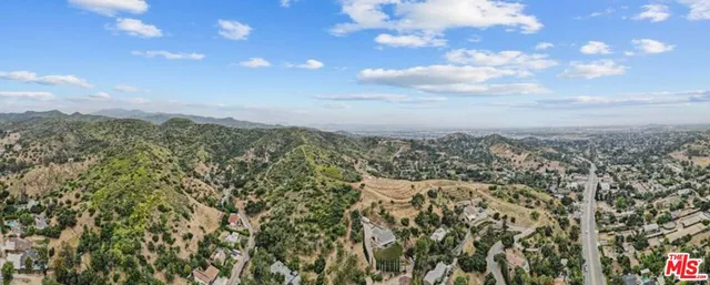 a view of a city with lush green forest