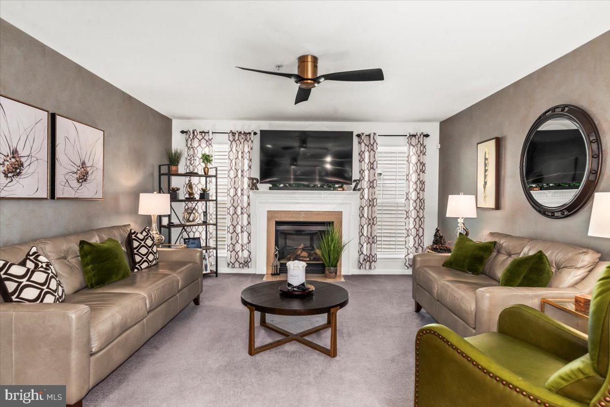 16308 Eddinger Road Bowie, MD 20716 - Photo 12 of 45 a living room with furniture a flat screen tv and a fireplace