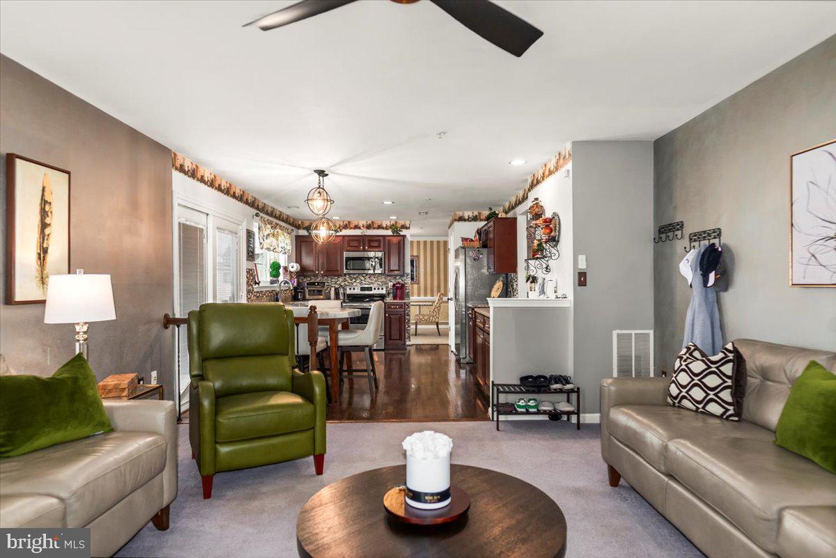 16308 Eddinger Road Bowie, MD 20716 - Photo 13 of 45 a living room with furniture and a lamp