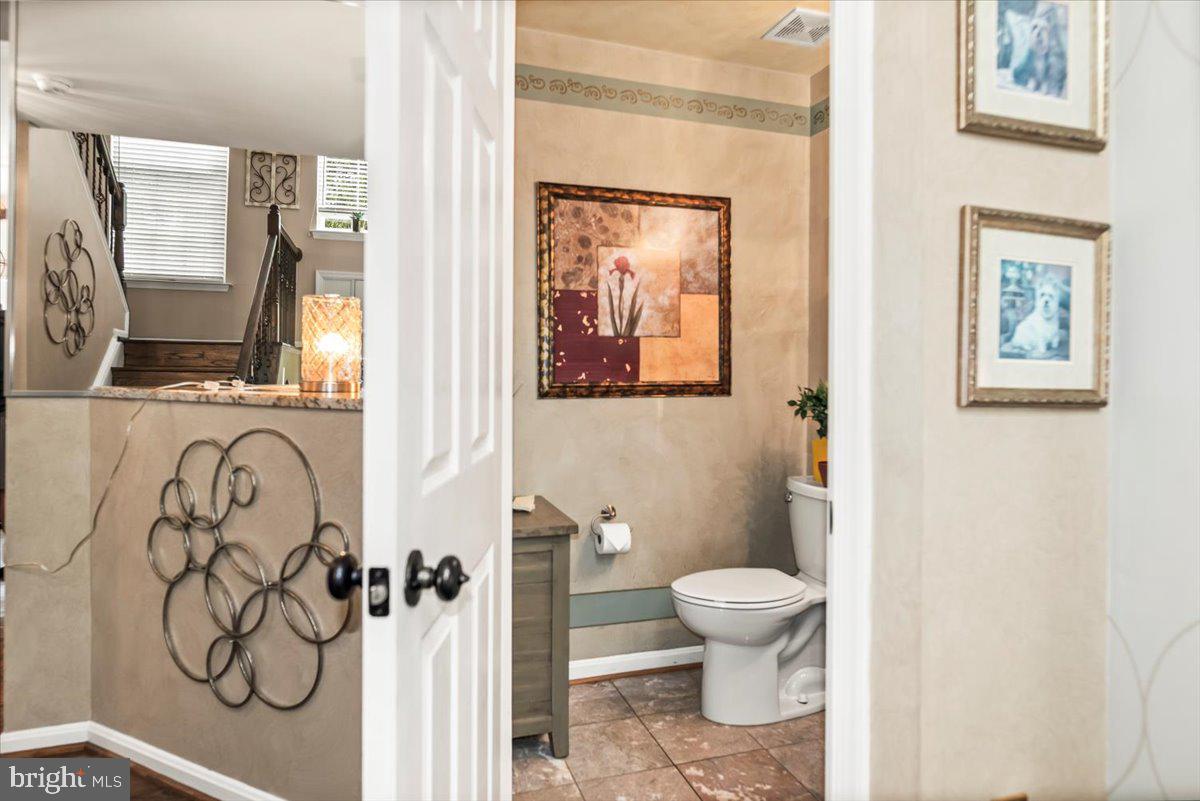 16308 Eddinger Road Bowie, MD 20716 - Photo 15 of 45 a bathroom with a toilet sink and mirror