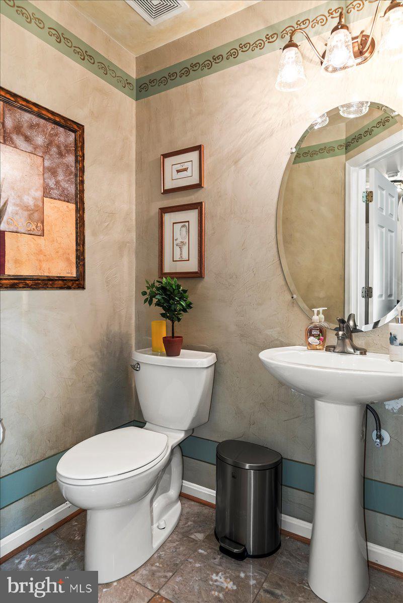 16308 Eddinger Road Bowie, MD 20716 - Photo 16 of 45 a bathroom with a toilet a sink and mirror