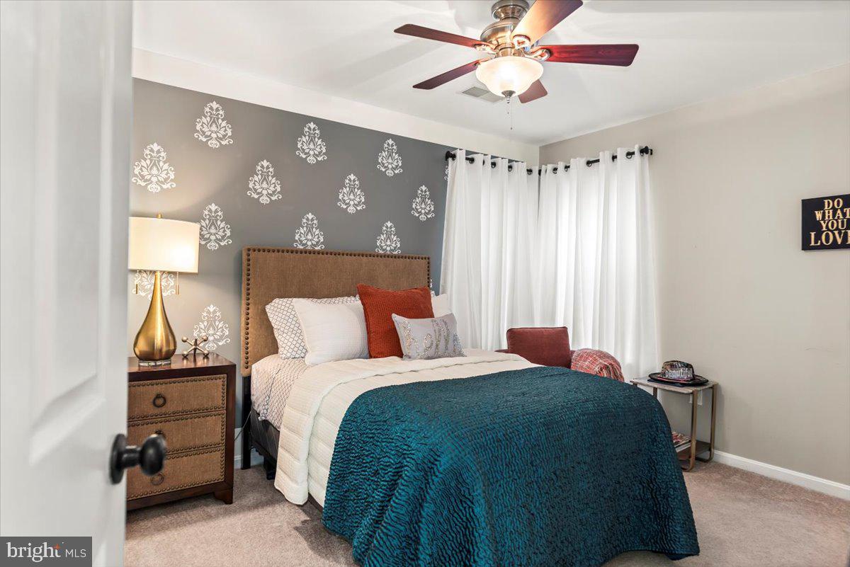 16308 Eddinger Road Bowie, MD 20716 - Photo 21 of 45 a bedroom with a bed and a chandelier