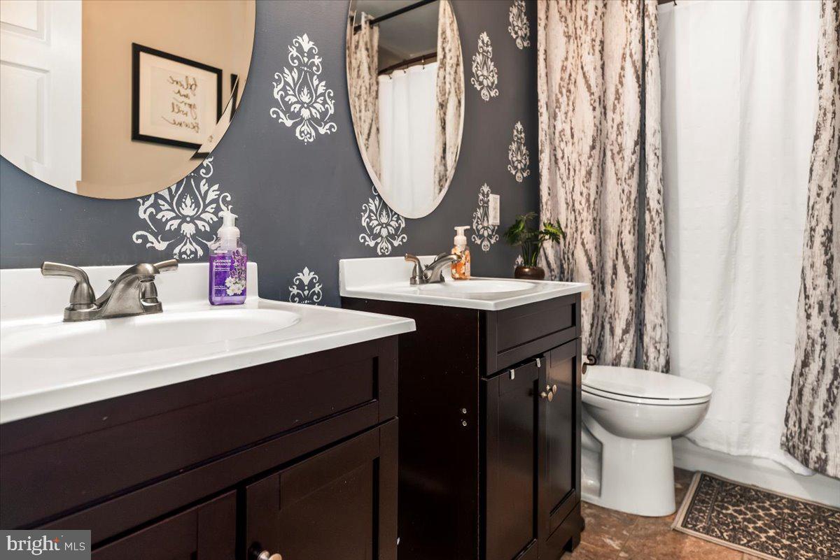 16308 Eddinger Road Bowie, MD 20716 - Photo 22 of 45 a bathroom with a sink a toilet and a mirror