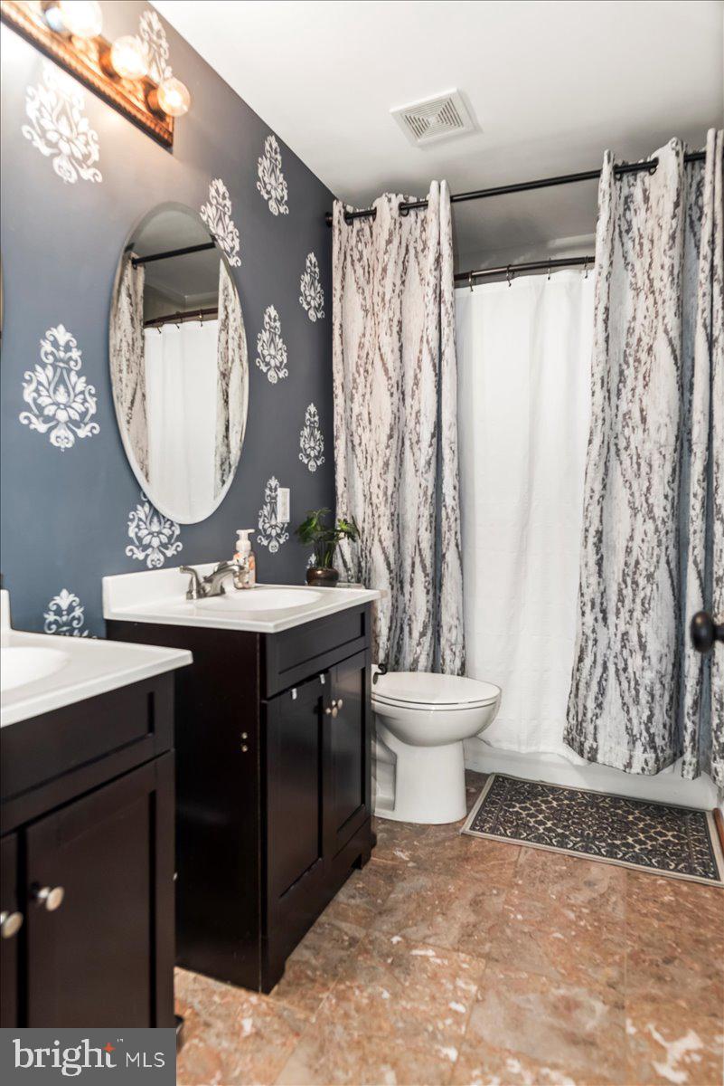 16308 Eddinger Road Bowie, MD 20716 - Photo 23 of 45 a bathroom with a sink toilet and a mirror