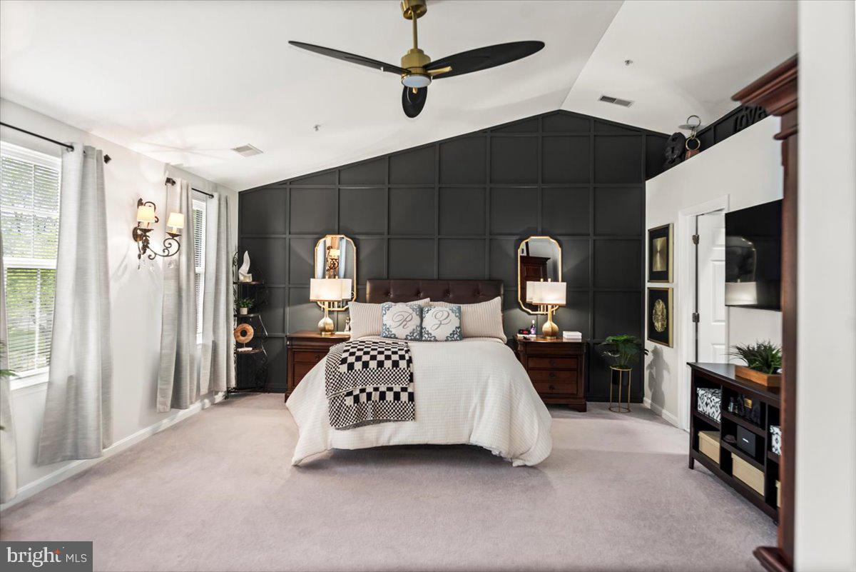 16308 Eddinger Road Bowie, MD 20716 - Photo 26 of 45 a bedroom with a bed next to a window and a chandelier