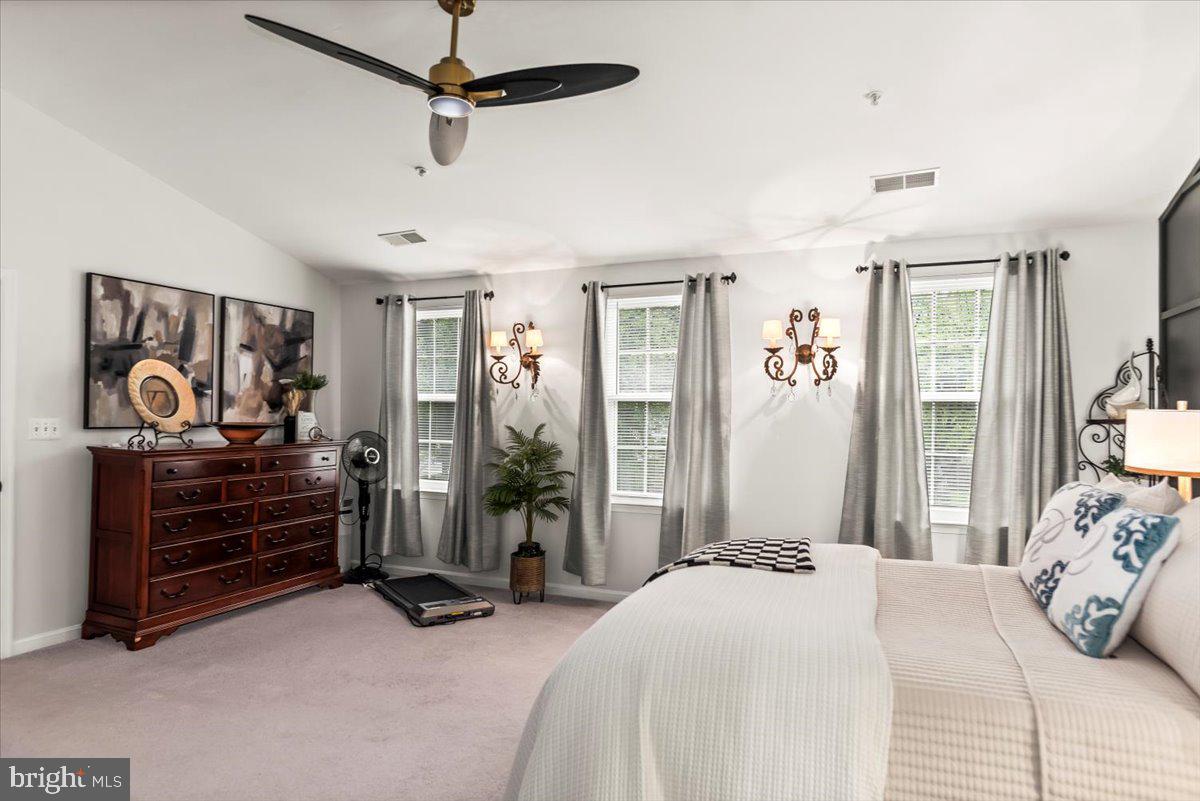 16308 Eddinger Road Bowie, MD 20716 - Photo 28 of 45 a bedroom with a bed and a chandelier