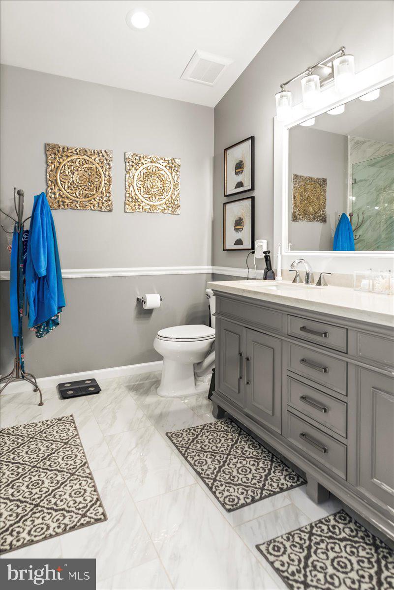 16308 Eddinger Road Bowie, MD 20716 - Photo 30 of 45 a bathroom with a sink a toilet and a mirror