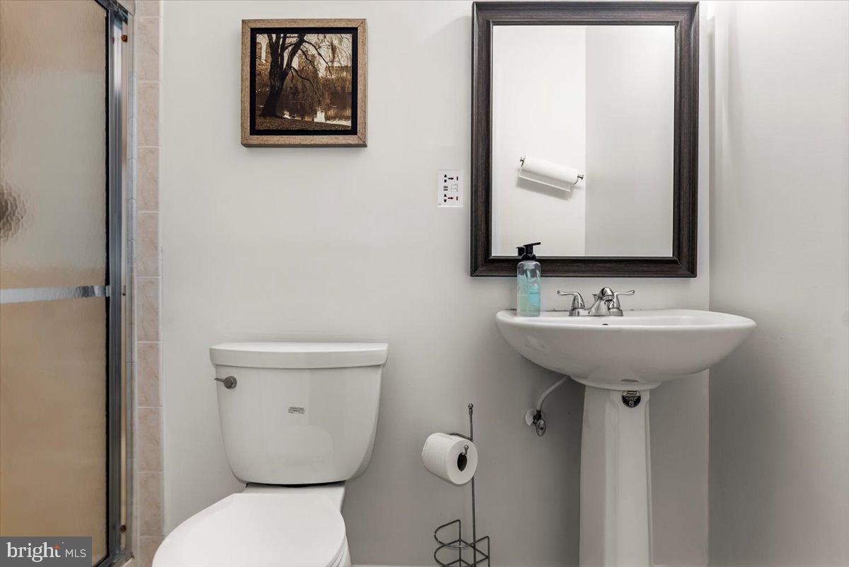 16308 Eddinger Road Bowie, MD 20716 - Photo 40 of 45 a bathroom with a toilet sink and mirror